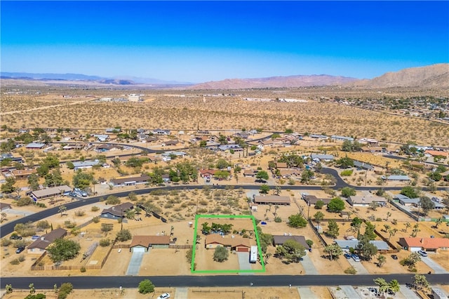 birds eye view of property with a mountain view