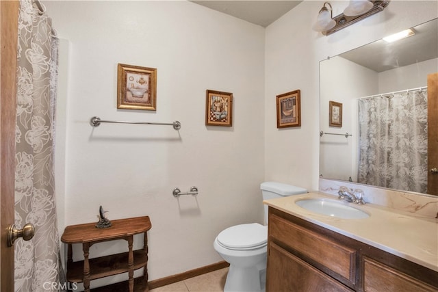 bathroom with tile patterned flooring, vanity, and toilet