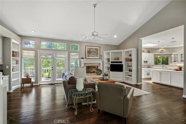 living room featuring sink, ceiling fan, high vaulted ceiling, dark hardwood / wood-style floors, and french doors