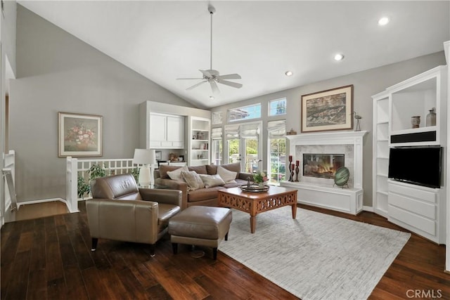 living room featuring ceiling fan, dark hardwood / wood-style floors, and vaulted ceiling