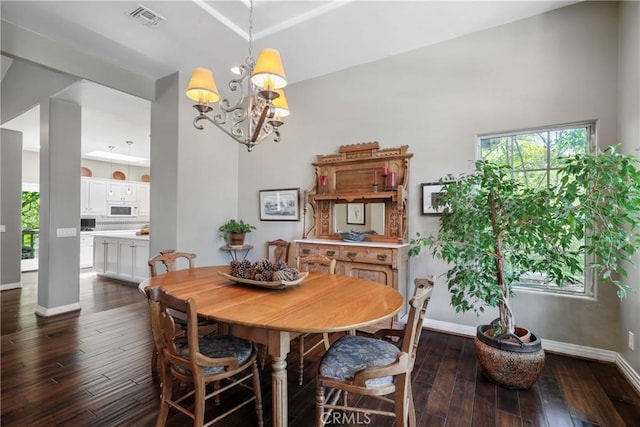 dining area featuring a notable chandelier and dark hardwood / wood-style flooring