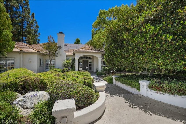 mediterranean / spanish-style house featuring solar panels