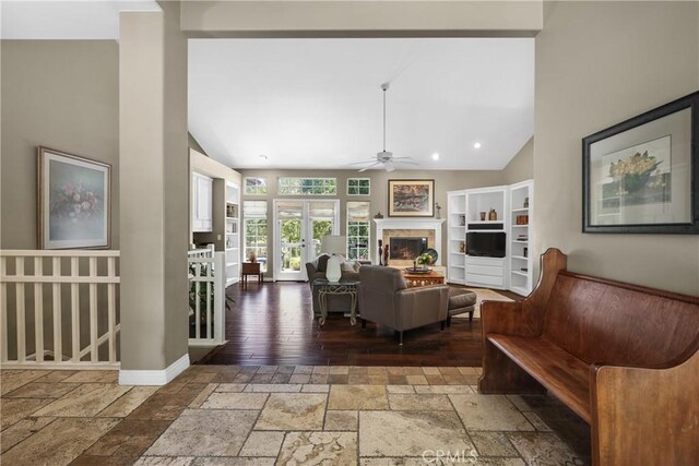 living room with ceiling fan and vaulted ceiling