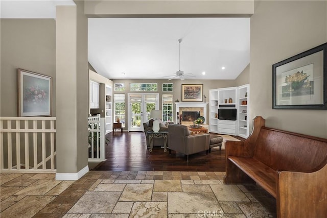 living room featuring vaulted ceiling and ceiling fan