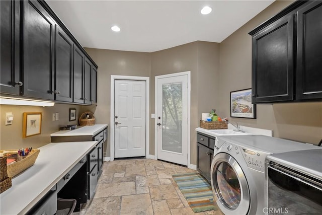 washroom featuring sink, cabinets, and washing machine and clothes dryer