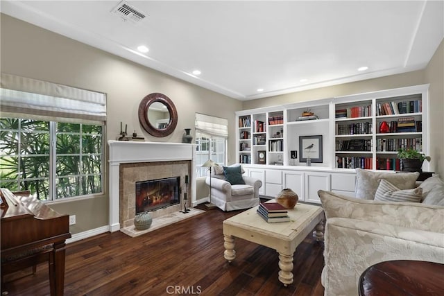 living room with dark wood-type flooring and a fireplace