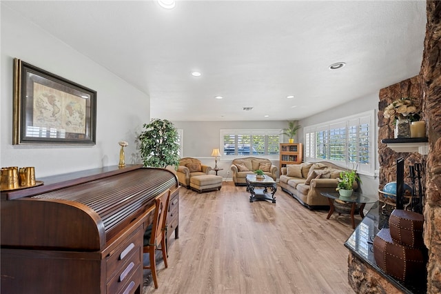 living room with a fireplace and light hardwood / wood-style floors