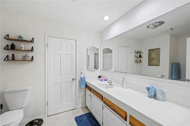 bathroom with tile patterned floors, vanity, and toilet