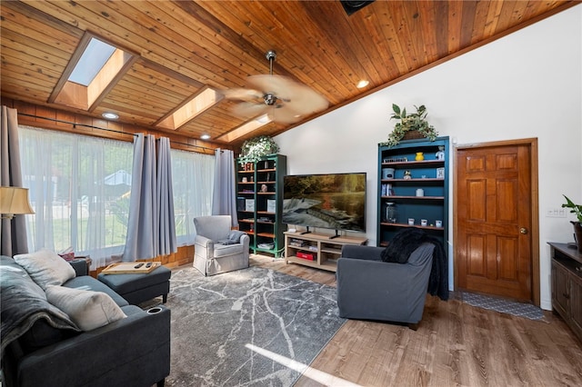 living room featuring lofted ceiling with skylight, wooden ceiling, ceiling fan, ornamental molding, and wood-type flooring