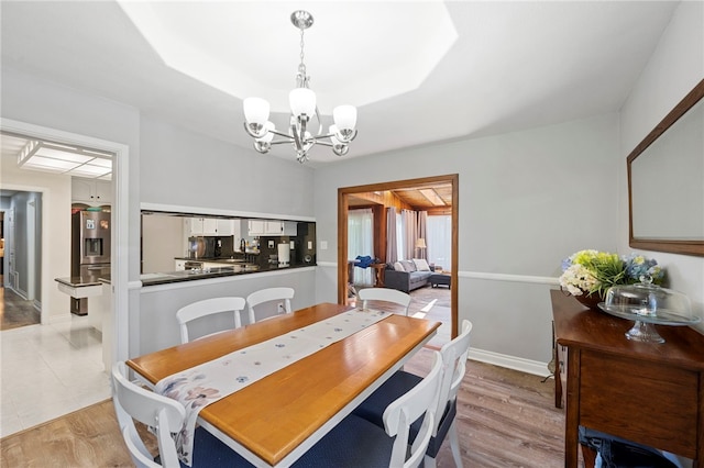 dining area featuring an inviting chandelier and light hardwood / wood-style flooring