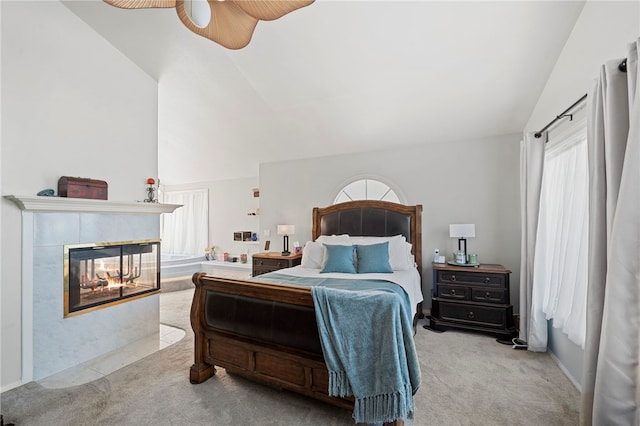 bedroom with light carpet, a multi sided fireplace, ceiling fan, and lofted ceiling