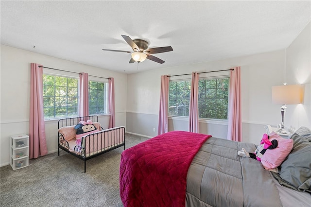 bedroom featuring ceiling fan, carpet floors, and a textured ceiling