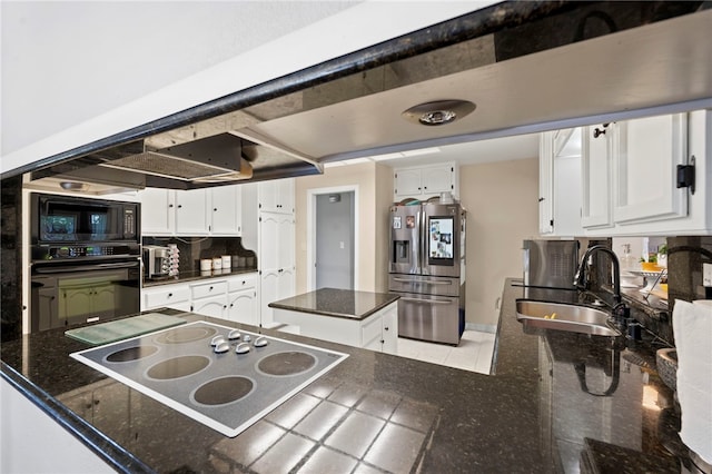 kitchen with sink, a kitchen island, backsplash, white cabinets, and black appliances