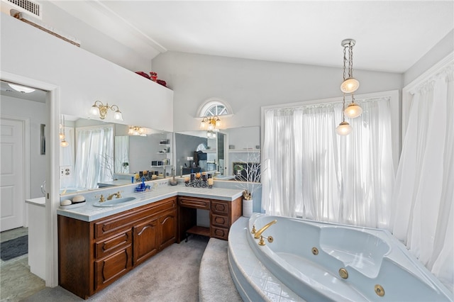 bathroom with vanity, a relaxing tiled tub, and vaulted ceiling