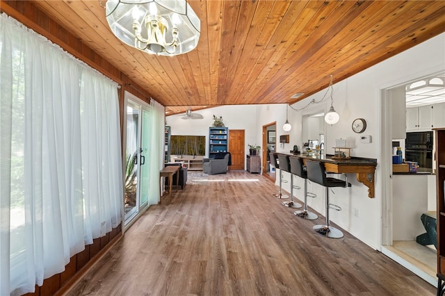 living room with wood ceiling, ceiling fan, wood-type flooring, and lofted ceiling