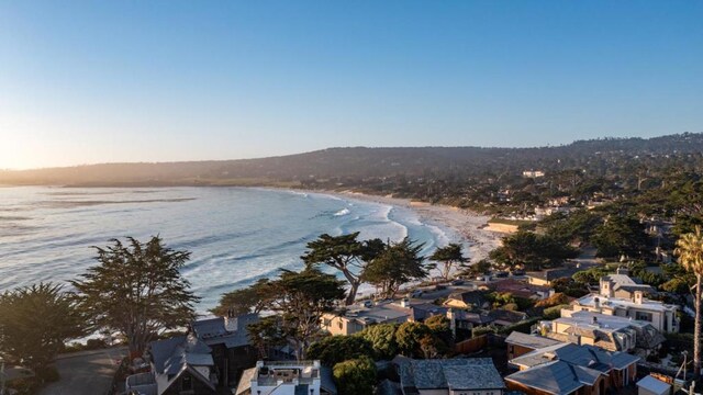 drone / aerial view featuring a beach view and a water view