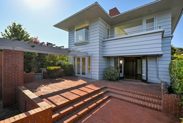 rear view of house featuring a patio and french doors