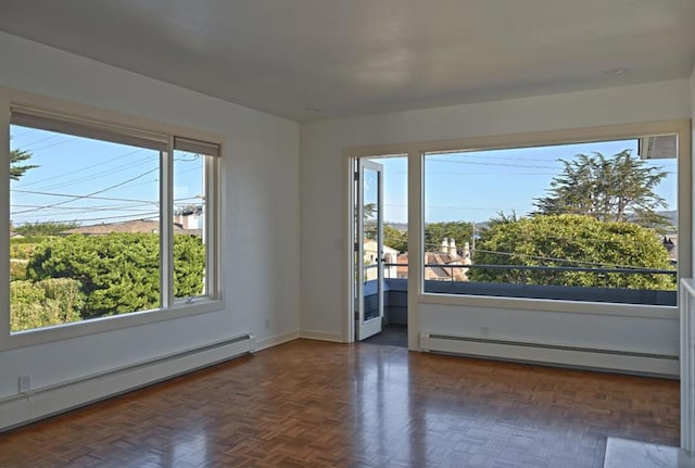 unfurnished room featuring dark parquet flooring and a baseboard radiator