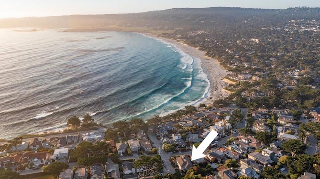 drone / aerial view with a water view and a beach view