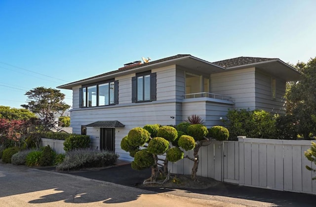 view of front of house featuring a balcony