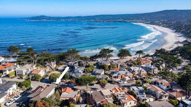 bird's eye view with a water view and a beach view