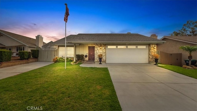 ranch-style house with a lawn and a garage