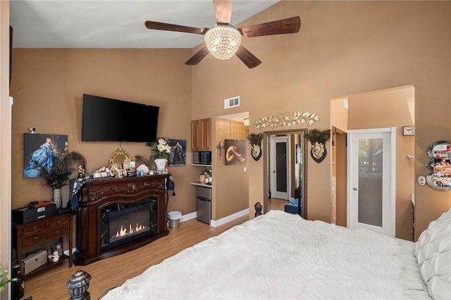 bedroom featuring vaulted ceiling, ceiling fan, and light hardwood / wood-style flooring