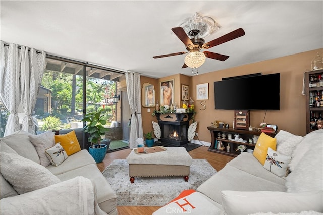 living room featuring ceiling fan and hardwood / wood-style floors