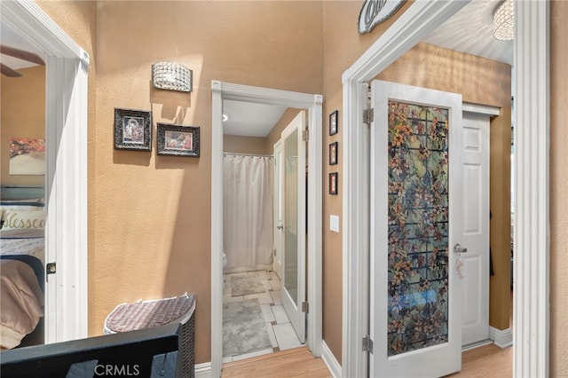 corridor with light hardwood / wood-style floors