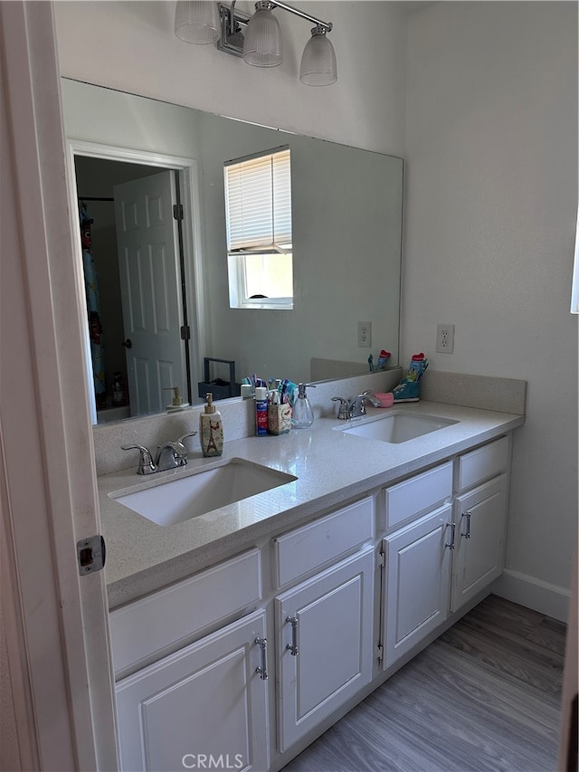 bathroom featuring hardwood / wood-style flooring and vanity