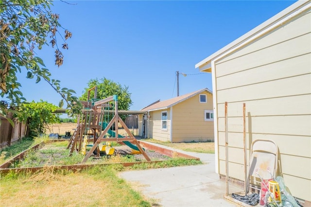 view of yard featuring a playground and fence