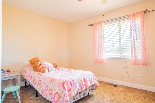 carpeted bedroom with baseboards and visible vents