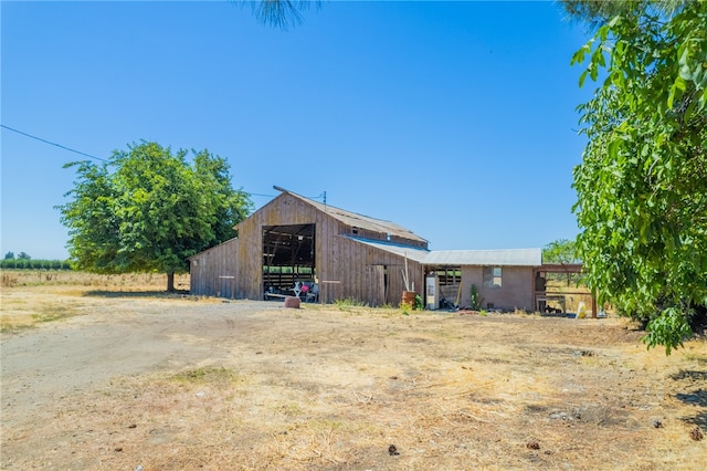 exterior space with a rural view and an outbuilding