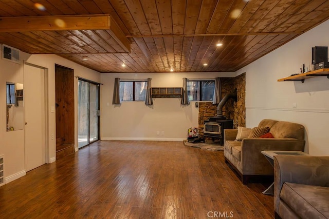 unfurnished living room featuring dark hardwood / wood-style flooring, a wood stove, and wood ceiling