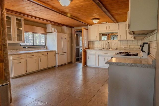 kitchen with white fridge, stove, wood ceiling, and light tile patterned floors