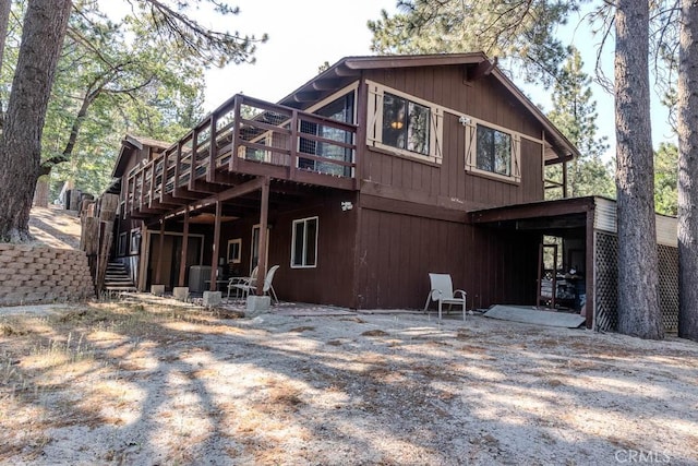 back of house with a wooden deck