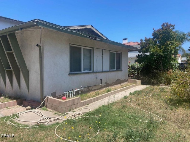 view of home's exterior with a yard