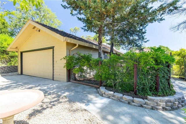 view of front of home with a garage and an outbuilding