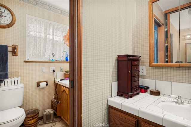 bathroom featuring toilet and vanity