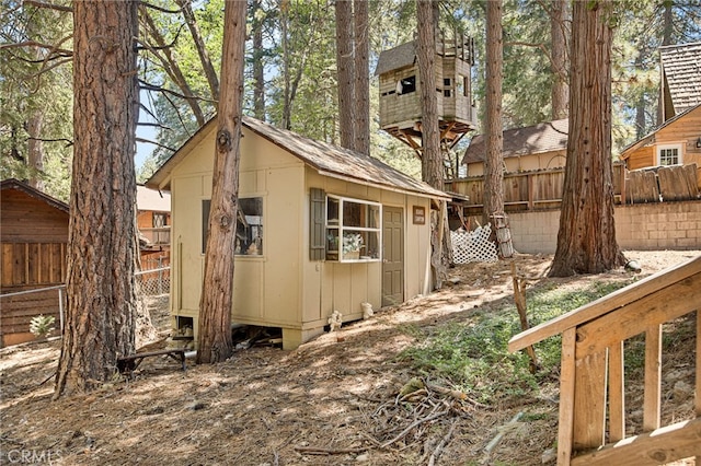 view of side of home featuring an outbuilding