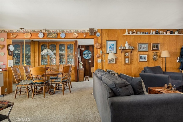 living room with wooden walls and carpet