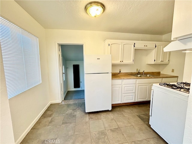 kitchen with white cabinets, sink, white appliances, and extractor fan