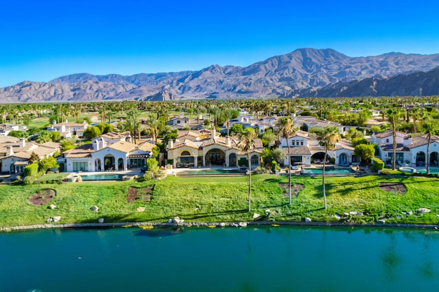 drone / aerial view featuring a water and mountain view