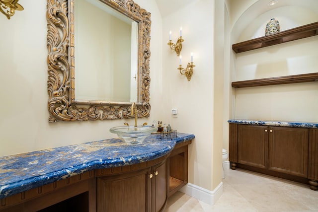 bathroom with vanity, tile patterned flooring, and toilet