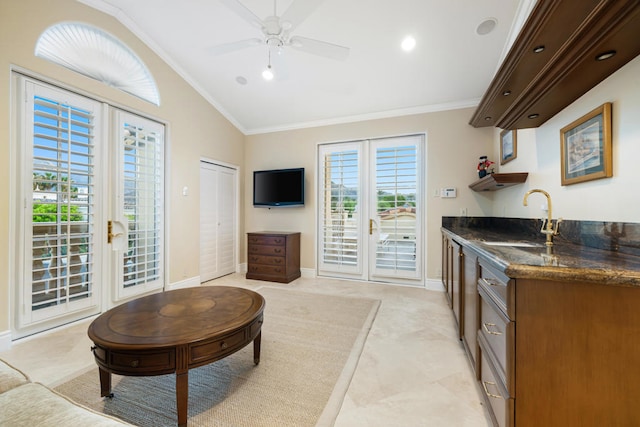 kitchen with ceiling fan, lofted ceiling, sink, french doors, and crown molding