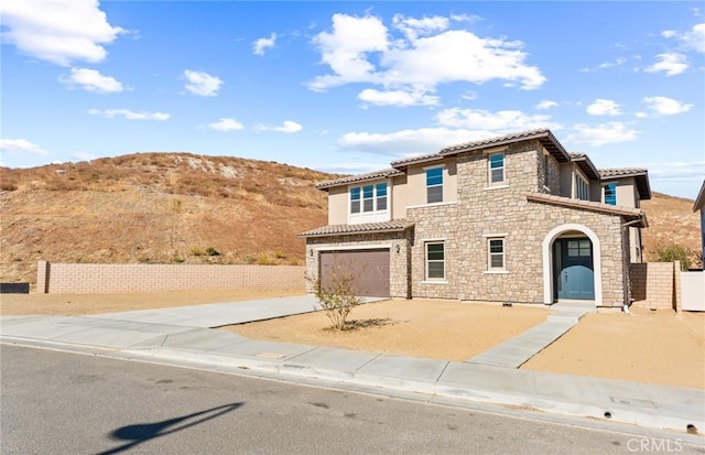 mediterranean / spanish-style home featuring a mountain view and a garage