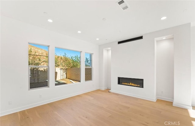 unfurnished living room with light wood-type flooring