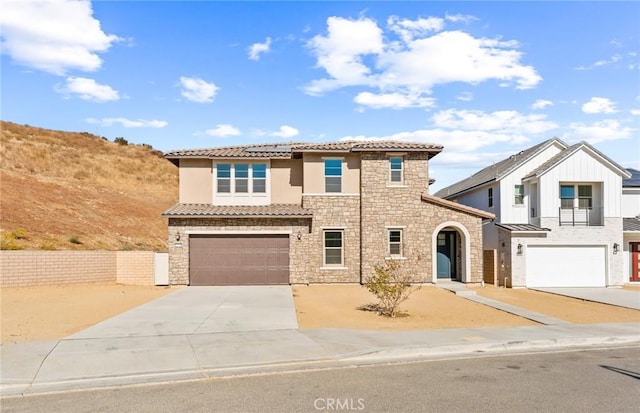 mediterranean / spanish-style home with a garage