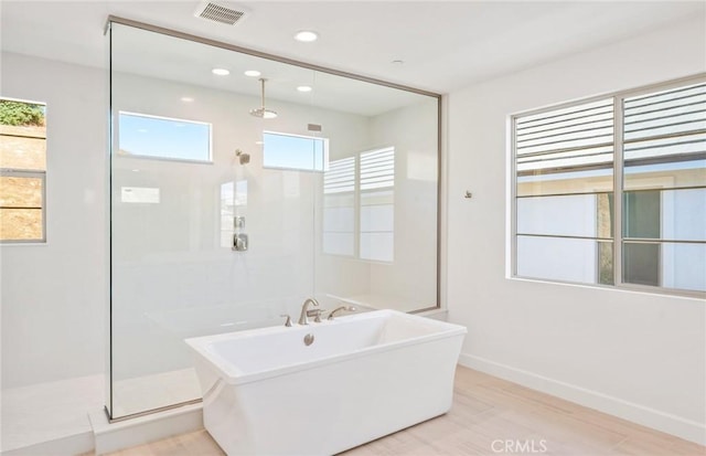 bathroom featuring hardwood / wood-style floors and shower with separate bathtub