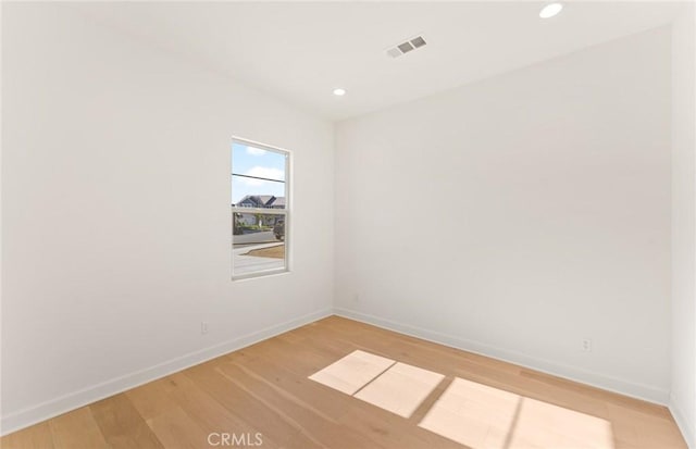 unfurnished room with light wood-type flooring